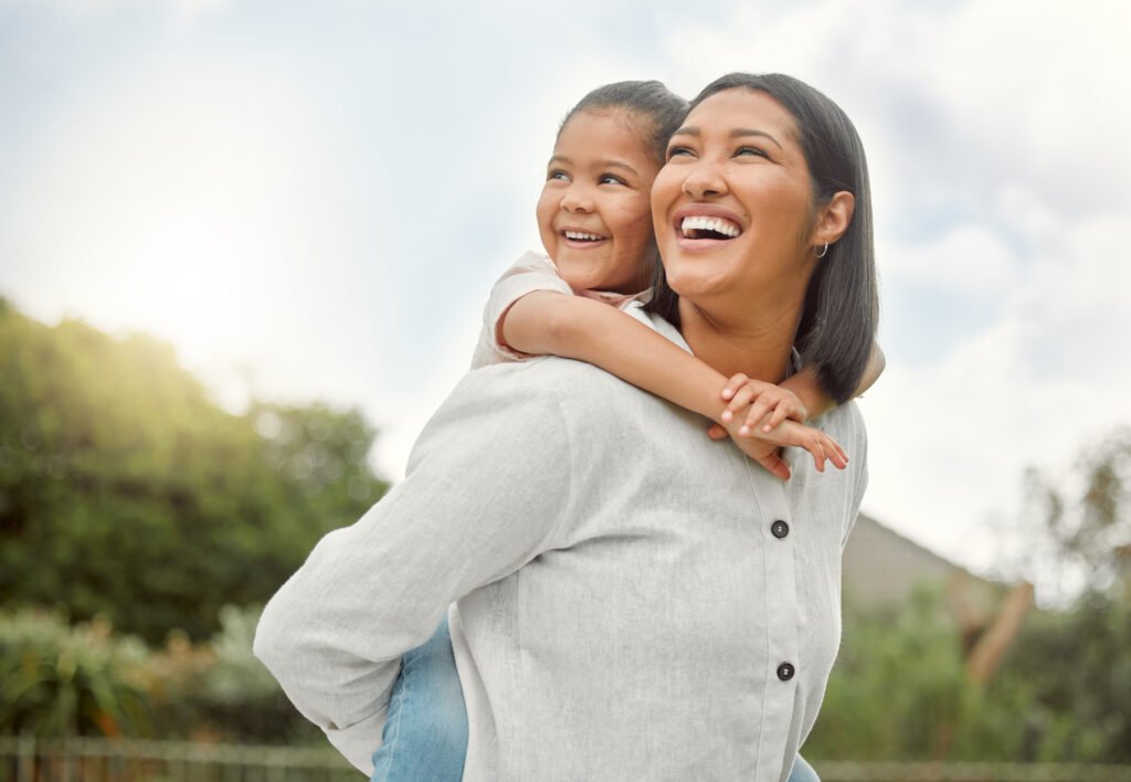 Shot of an adorable little girl embracing her mother at the park