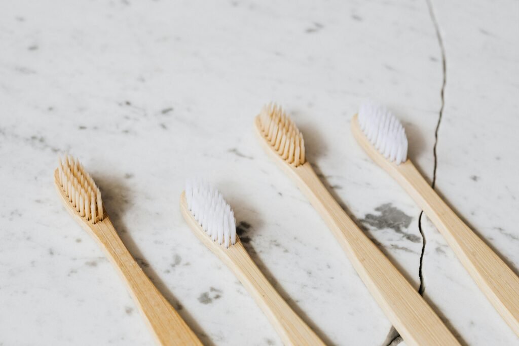 4 bamboo toothbrushes on marble counter