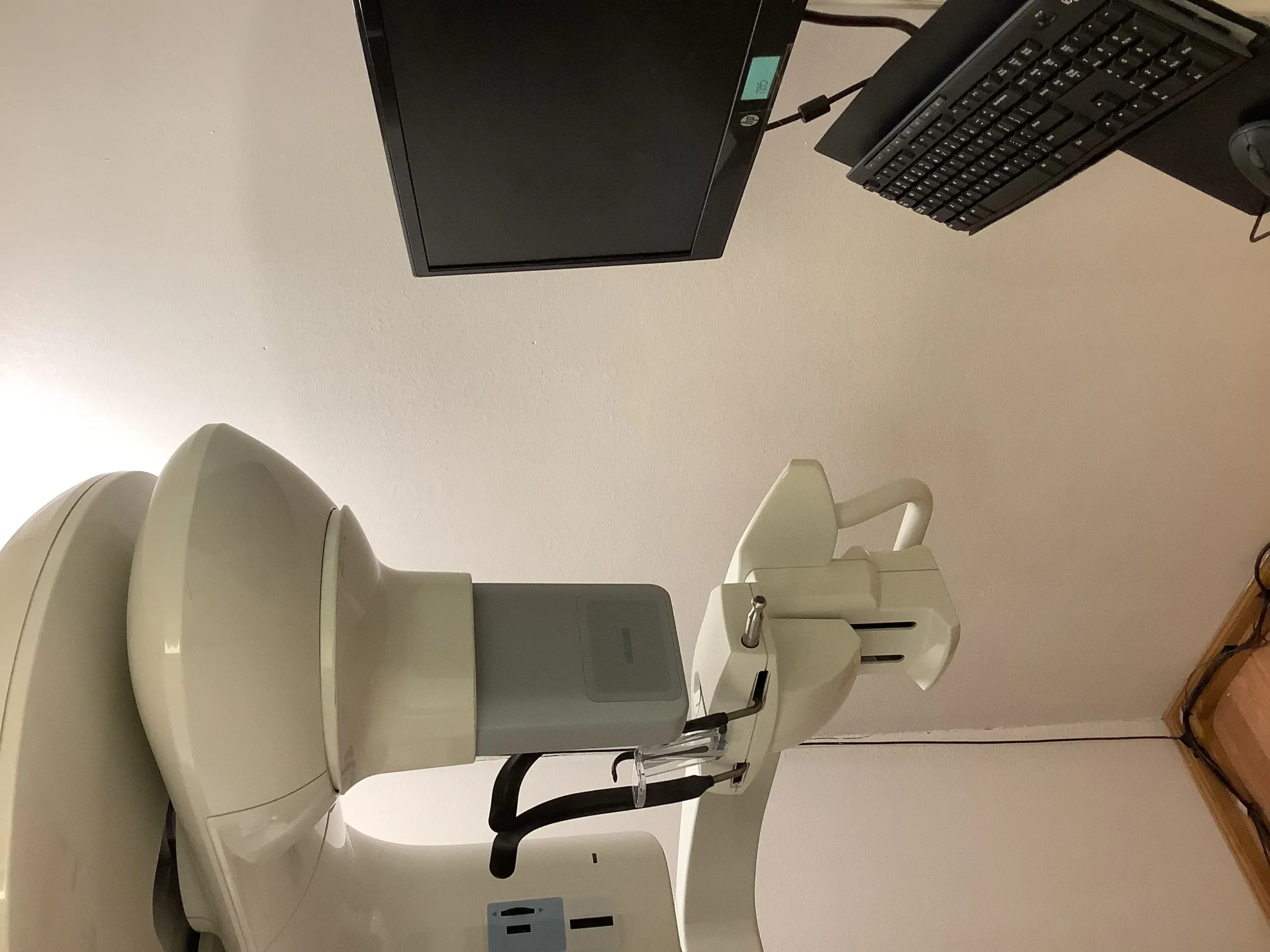 Medical imaging machine with a computer and keyboard in a clinical setting