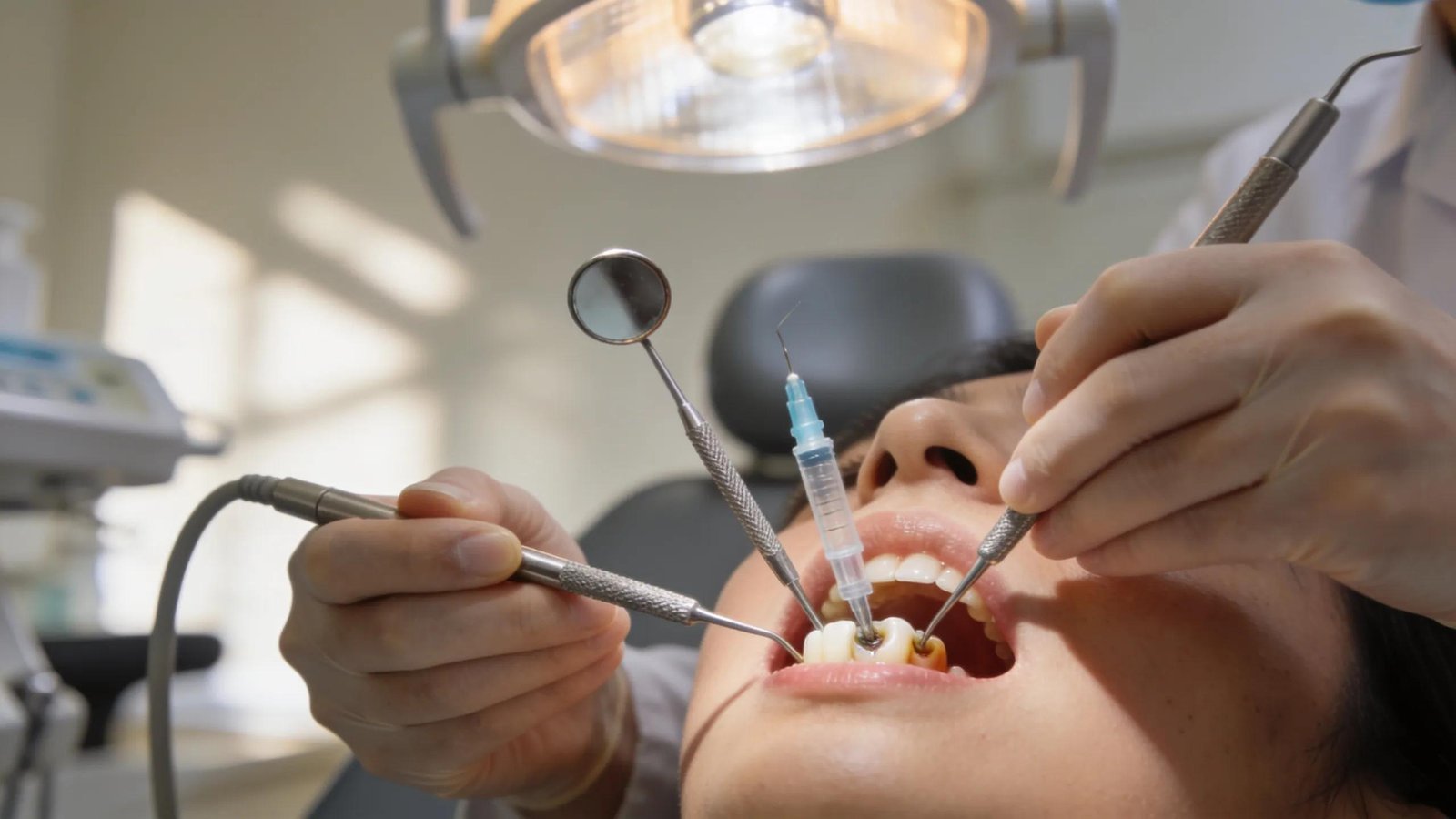 Dental examination and treatment with tools and syringe, emergency dental care services.