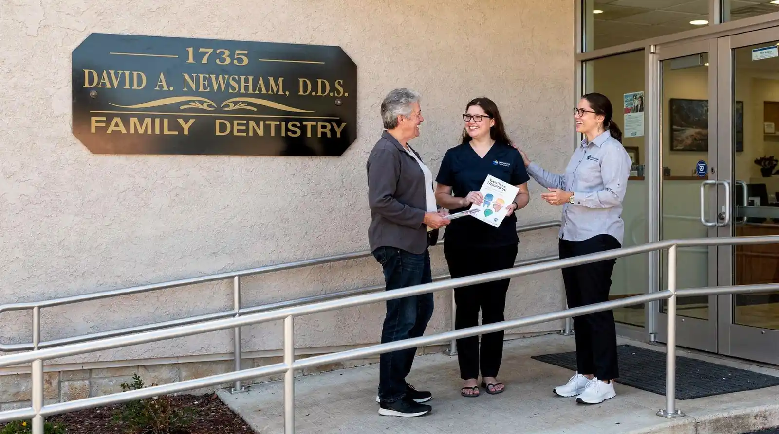David A. Newsham DDS family dentistry office exterior, patients consulting with staff about replacement options