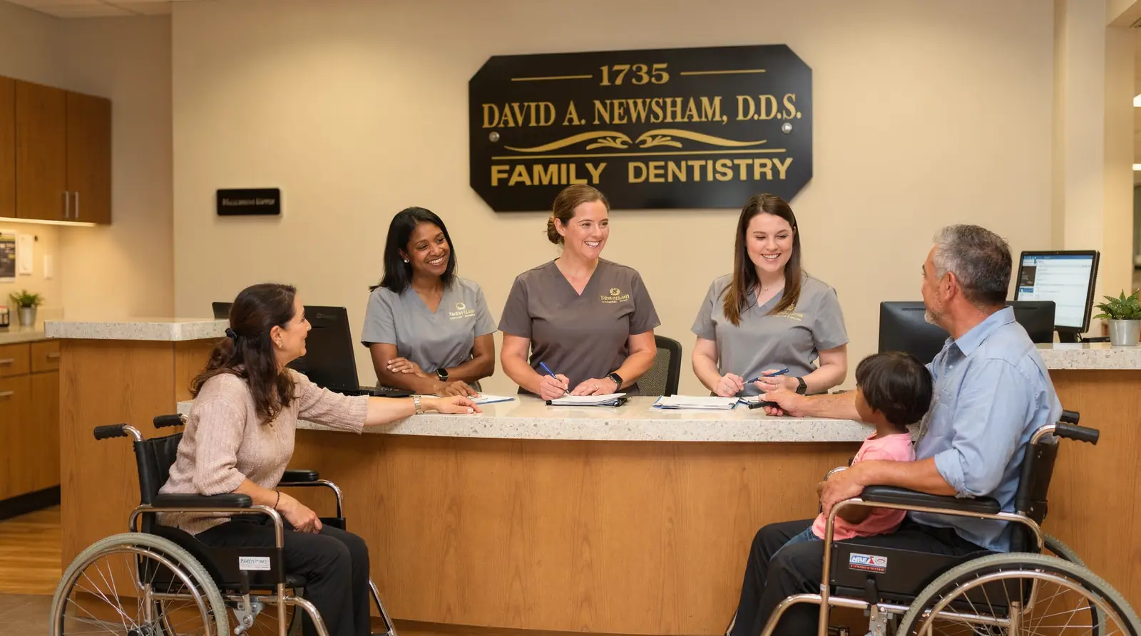 David A. Newsham DDS family dentistry reception area, staff welcoming patients including wheelchair users, discussing