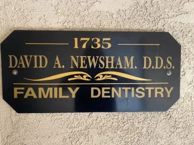 Black and gold sign for David A. Newsham, D.D.S., Family Dentistry